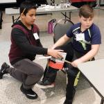 Boys at MS Challenge work on prosthetic leg design